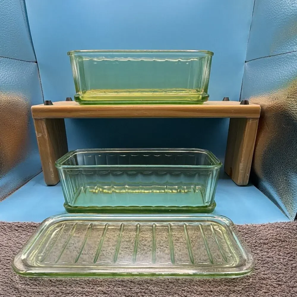 Uranium depression glass refrigerator dishes from the 30’s glows green. One lid.
